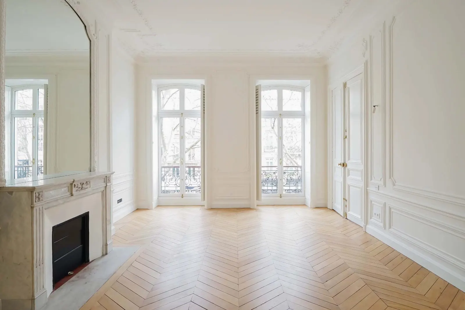 Salon haussmannien rénové — parquet, moulures et cheminée